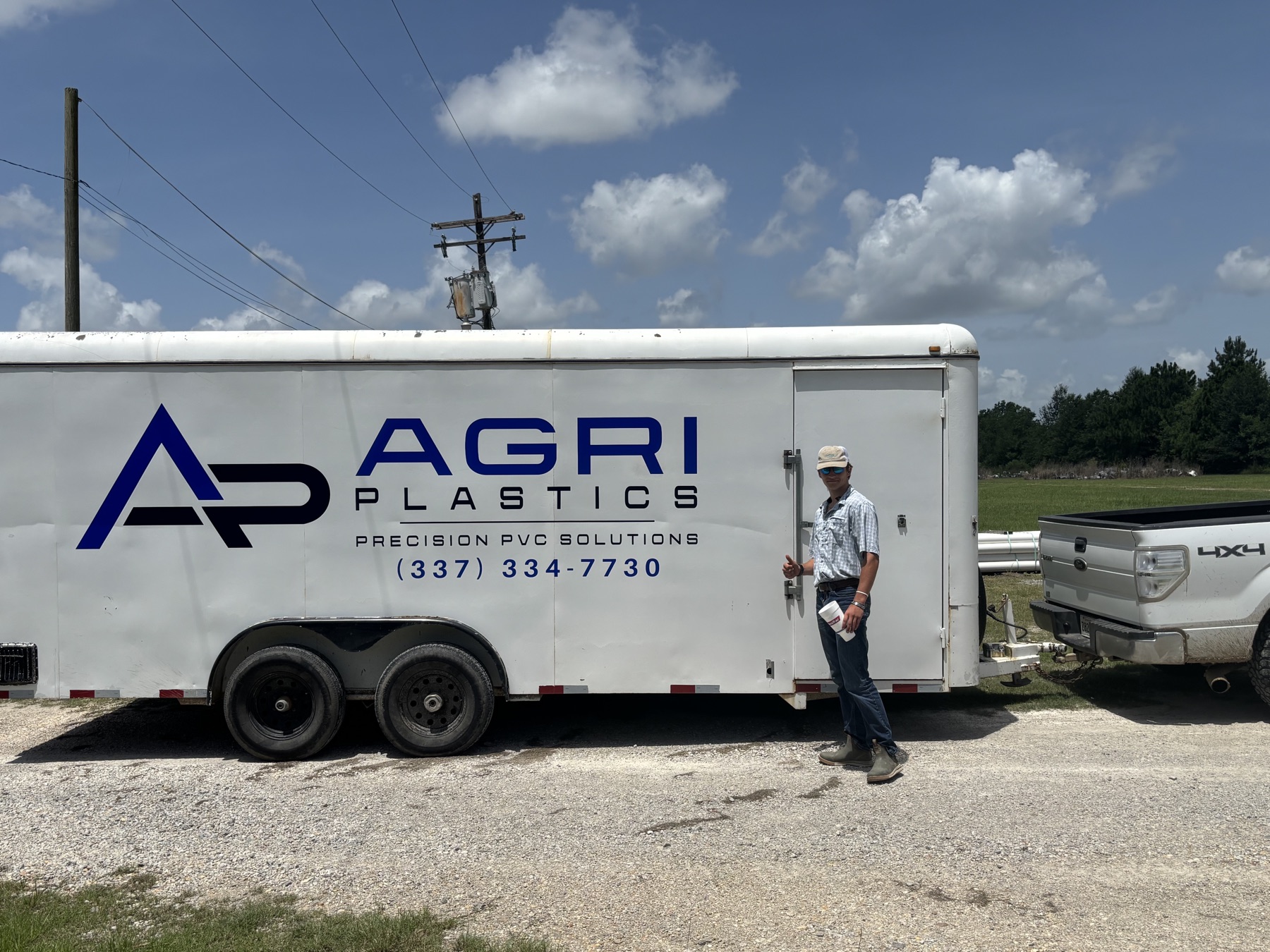 Agri Plastics team member with company trailer